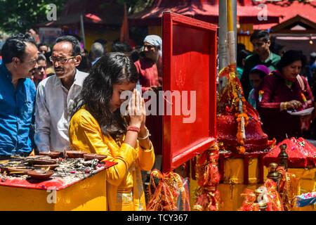 A devotee prays at the Kheer Bhawani temple during the annual Hindu festival in Ganderbal district, about 30kms northeast of Srinagar, Kashmir. Thousands of Kashmiri Hindus, many of whom were displaced 20 years ago, attended the festival in order to worship the Hindu goddess Mata Kheer Bhawani on the day of her birth.  Some 200,000 Kashmiri Pandits fled the region in the early nineties at the start of an insurgency against Indian rule mainly to the Hindu-dominated southern city of Jammu and they return yearly for the festival. Stock Photo