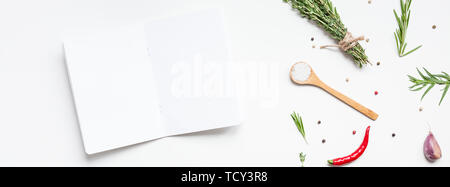 Flat lay overhead view blank notebook pages mockup text space invitation card on white background with greens herbs and spices. Menu or recipe book or Stock Photo