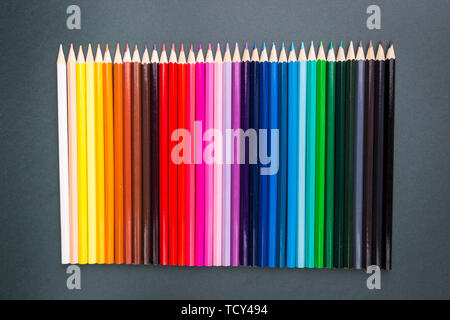 Pencils of various colors on a black background, top view with copy space, flat lay Stock Photo