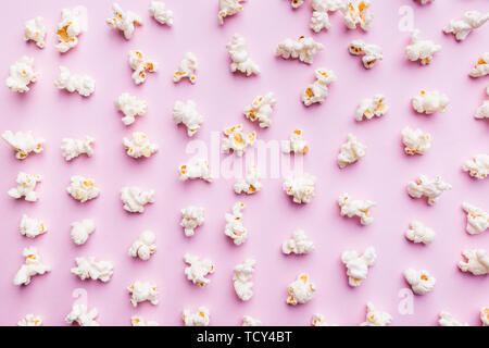 Fresh popcorn isolated on pink background top view. Composition with copy space. Stock Photo