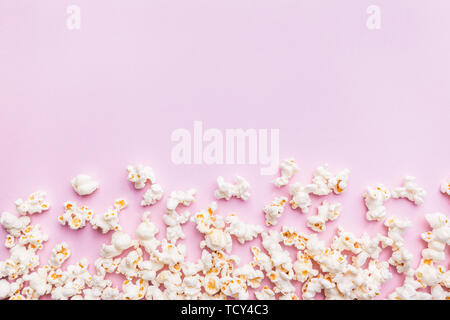 Fresh popcorn isolated on pink background top view. Composition with copy space. Stock Photo