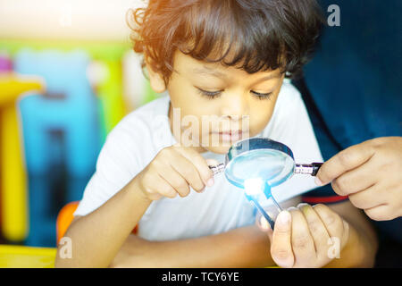 3 year old children in Asia are conducting scientific experiments for education. Stock Photo