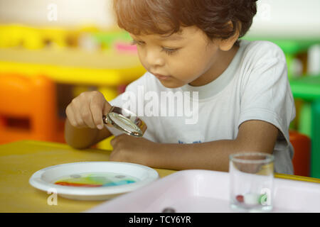 3 year old children in Asia are conducting scientific experiments for education. Stock Photo
