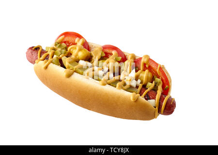 Tasty hot dog with tomatoes and pickled relish on white Stock Photo