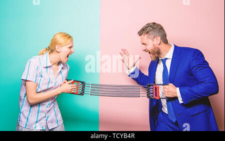 Gender equality and discrimination. Gender rivalry concept. Man and woman stretching expander opposite sides. Business rivalry guy and girl. Gender confrontation at workplace. Gender equal rights. Stock Photo