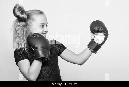 Sport and sportswear fashion. training with coach. Fight. Boxer child workout, healthy fitness. knockout and energy. Sport success. little girl in boxing gloves punching. Born to fight. Stock Photo