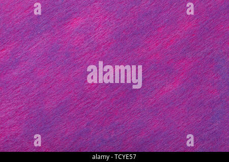 Structure of dark purple background with blue spots of felt fabric, closeup. Texture of woolen magenta matt textile. Cloth backdrop. Stock Photo
