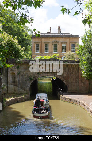 Kennet and Avon Canal, Bath Somerset England UK - a canal boat going under a bridge on  a sunny summer day in June Stock Photo