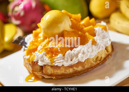Mango ice cream stacked on muffins Stock Photo