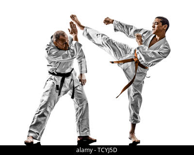 two karate men sensei and teenager student fighters fighting isolated on white background Stock Photo