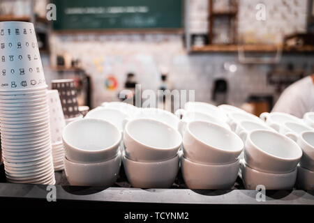 Stack of small ceramic cups on shelf. Stock Photo