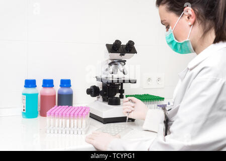 Scientist researcher using microscope in laboratory. Medical healthcare technology and pharmaceutical research and development concept . Stock Photo