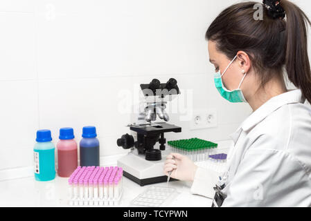 Scientist researcher using microscope in laboratory. Medical healthcare technology and pharmaceutical research and development concept . Stock Photo