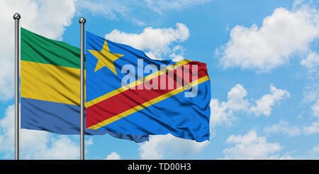 Gabon and Congo flag waving in the wind against white cloudy blue sky together. Diplomacy concept, international relations. Stock Photo