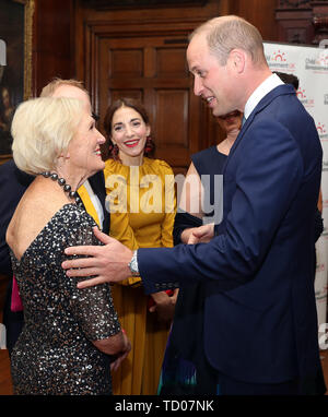 LONDON, ENGLAND - JUNE 10: Prince William, Duke of Cambridge greets Mary Berry CBE as he attends the Child Bereavement 25th birthday gala dinner at Kensington Palace on June 10, 2019 in London, England. HRH is a patron of Child Bereavement UK. The charity works to help families to rebuild their lives after the devastation of child bereavement. (Photo by Chris Jackson/Getty Images) Stock Photo