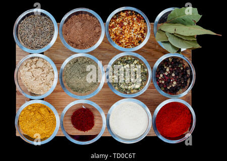 Set of various spices on wooden plank  isolated on black Stock Photo