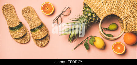 Summer apparel set and fresh fruits over pastel pink background Stock Photo