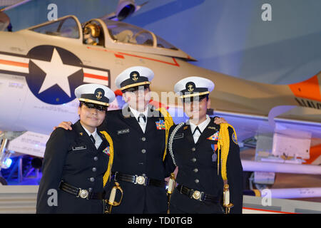 Garden City, New York, USA. 6th June, 2019. Three Freeport High School Navy Junior ROTC cadets wearing uniforms and about to participate at Apollo at 50 Anniversary Dinner at Cradle of Aviation Museum, pose for photo in front of historic aircraft at museum exhibit. Credit: Ann Parry/ZUMA Wire/Ģ����ý Live News Stock Photo