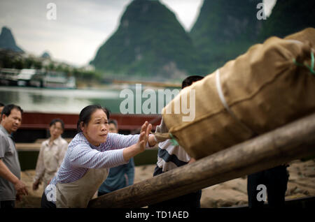 Chinese workers working loading cargo. Stock Photo
