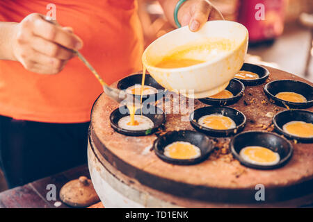 Vietnamese mini fried eggs, cooking on the street - Traditional Vietnamese foo Stock Photo