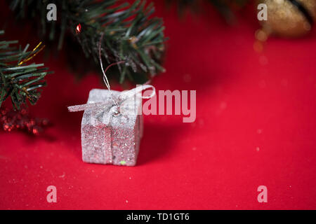 Christmas gift box next to the Christmas tree. Stock Photo