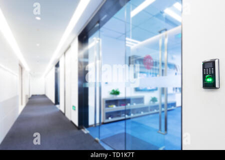 fingerprint scanner on wall in modern corridor Stock Photo