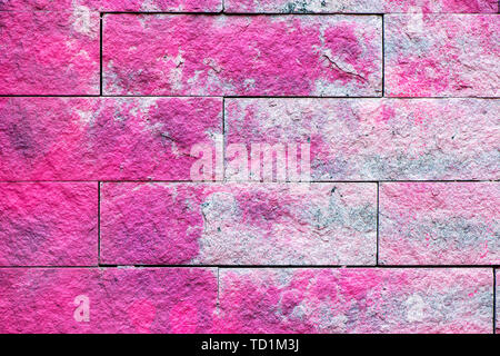 Colorful pink brick wall in grunge style. Festive holiday pastel backdrop. Grunge cement wall background. Stock Photo