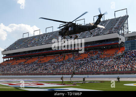 U.S. Army paratroopers assigned to the 82nd Airborne Division rappel from a UH-60 Black Hawk helicopter during a ceremony at Charlotte Motor Speedway before the Coca-Cola 600 race in Charlotte, North Carolina, May 26, 2019. The rappelling exercise demonstrated the division's readiness and capability to rapidly respond to contingencies anytime and anywhere. (U.S. Army photo by Spc. Justin W. Stafford) Stock Photo