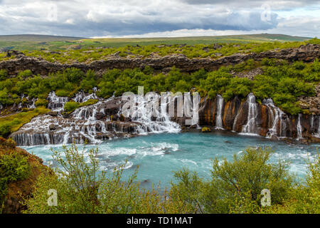 Hraunfossar waterfall powerful streams falling into Hvita river turquoise waters, Husafell, Western Iceland Stock Photo