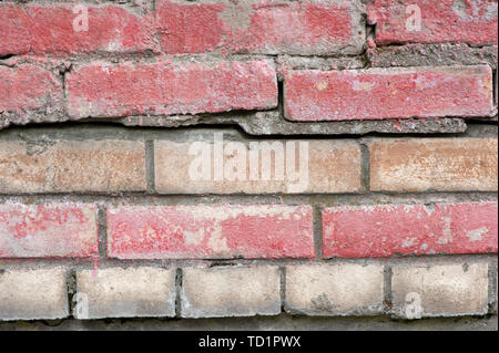 Weathered stained old brick wall for texture or background Stock Photo