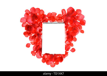 Red coral roses petals on heart shape and notebook isolated on white background. Stock Photo