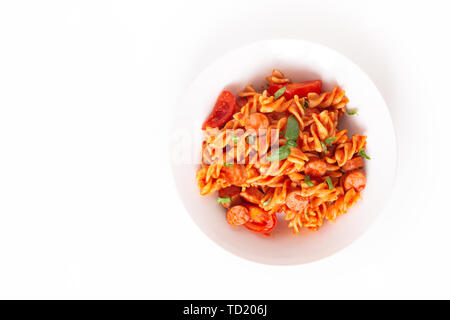 Food concept Homemade Fusilli pasta with tomato sauce in a white dish on white background Stock Photo