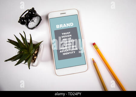 Brand concept. Smartphone on white table Stock Photo