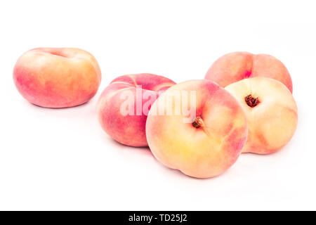 Vibrant organic flat saturn peaches on a white background with a place for text Stock Photo