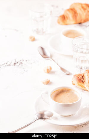 Traditional breakfast with fresh croissants on white background, vertical. Stock Photo