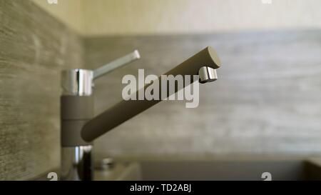 Tap for water in the sink in the kitchen. Faucet sink at kitchen - vintage light tone filter Stock Photo