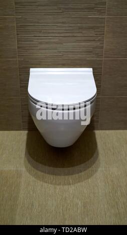 Mounted toilet bowl. Closed Toilet in the toilet Stock Photo