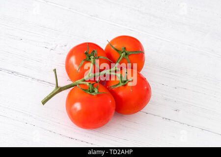 Scottish Summer Tomatoes on a white Wooden Planked Board and a very good image for a green grocer or similar Stock Photo