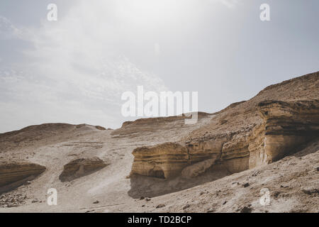 Mountain panorama in the Judean desert, Israel. Rocks and lifeless soil of hill, middle eastern climate. View of the deserted landscape against Stock Photo