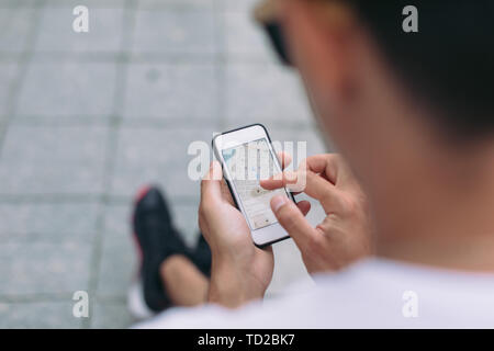 Man looking on navigation map. Travelers using gps map for sightseeing in town Stock Photo