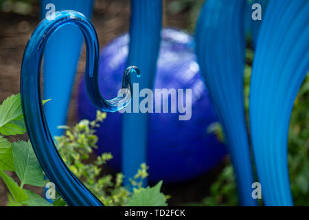 Turquoise Marlins and Floats by Dale Chihuly, part of a glass sculpture exhibit in Kew Gardens. Stock Photo