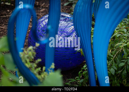 Turquoise Marlins and Floats by Dale Chihuly, part of a glass sculpture exhibit in Kew Gardens. Stock Photo