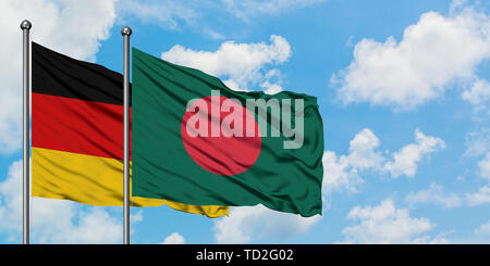 Germany and Bangladesh flag waving in the wind against white cloudy blue sky together. Diplomacy concept, international relations. Stock Photo