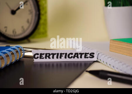 Certificates on the paper isolated on it desk. Business and inspiration concept Stock Photo