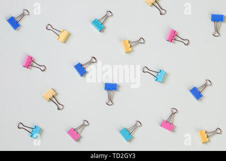 office concept,set of colorful paper clips isolated.business creativity concepts.Flat lay design. lot of multicolored paper clips scattered on pastel Stock Photo
