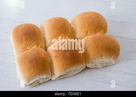 Six morning rolls cooling down on a white painted planked boarded tray Stock Photo