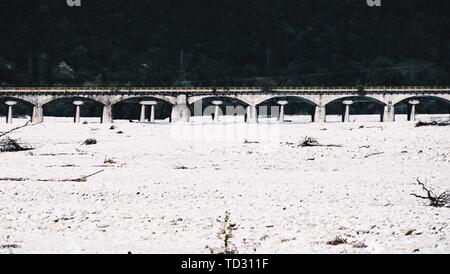 Highway stone bridge in a field covered in snow Stock Photo