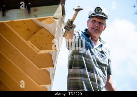worker roofer builder working on roof structure on construction site Stock Photo