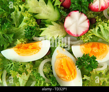 Fresh mixed salad with eggs, salad leaves and other vegetables, close up Stock Photo