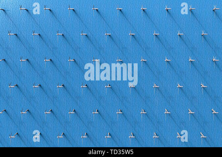 3D rendering of an aerial view of wind turbines in the ocean Stock Photo